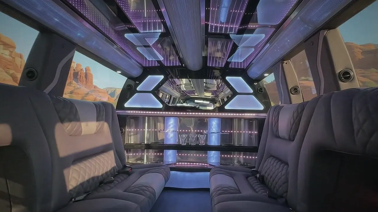 Inside the Cadillac Escalade limo in Mead: LED light-show ceiling, leather lounge seating and lit bar